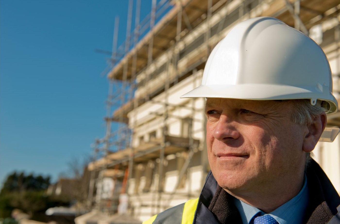 Construction Lead in front of construction site