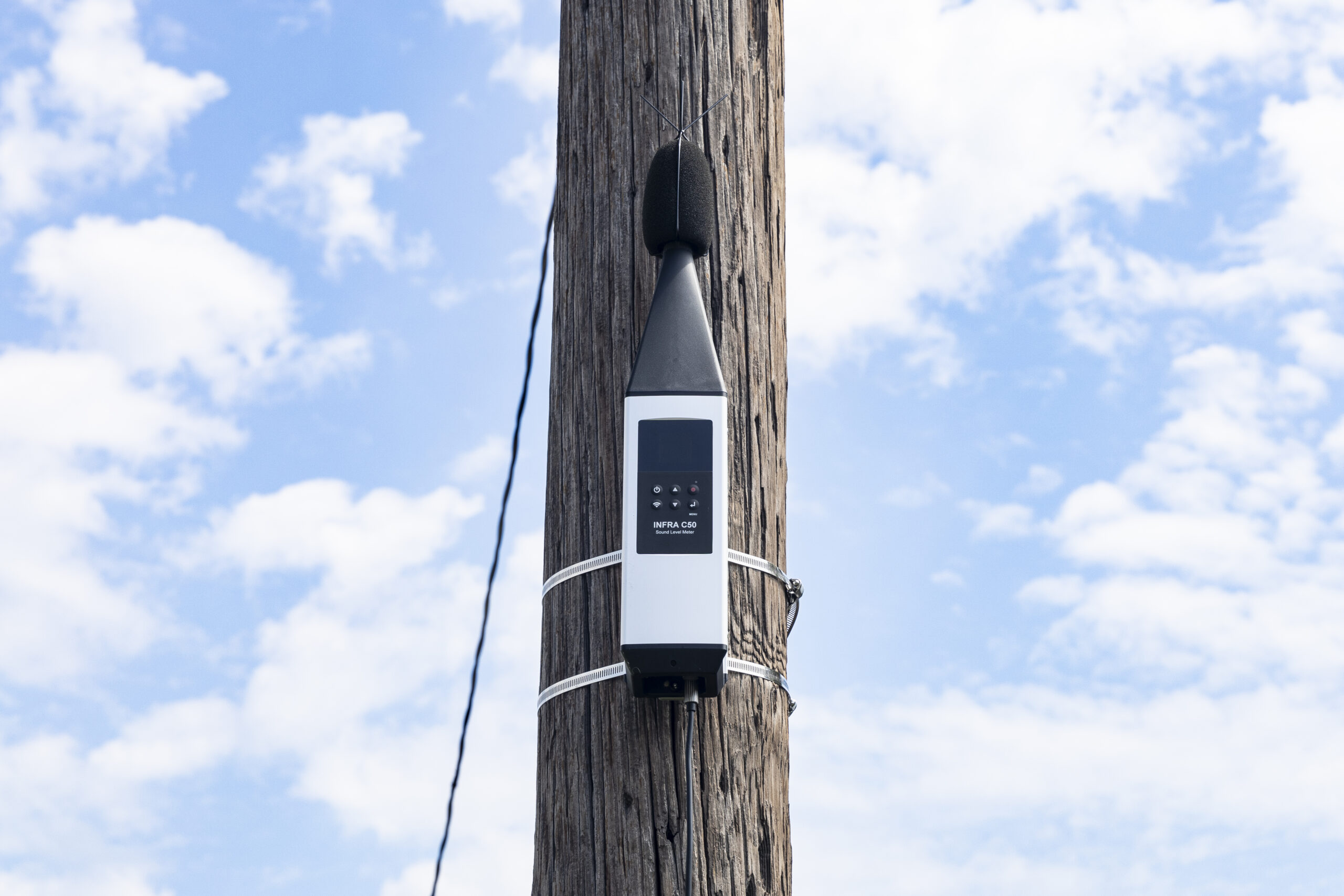 View of noise monitor on a pole