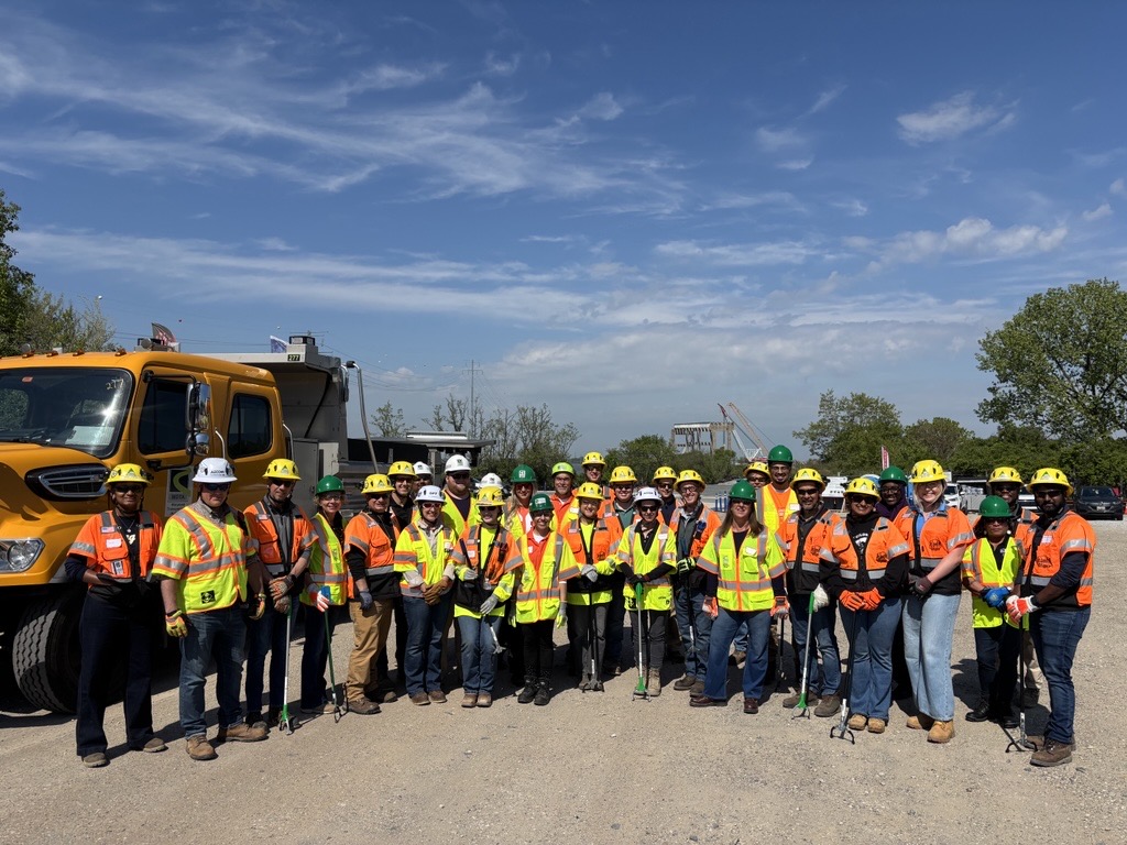 Group of people with hard hards and safety vests.