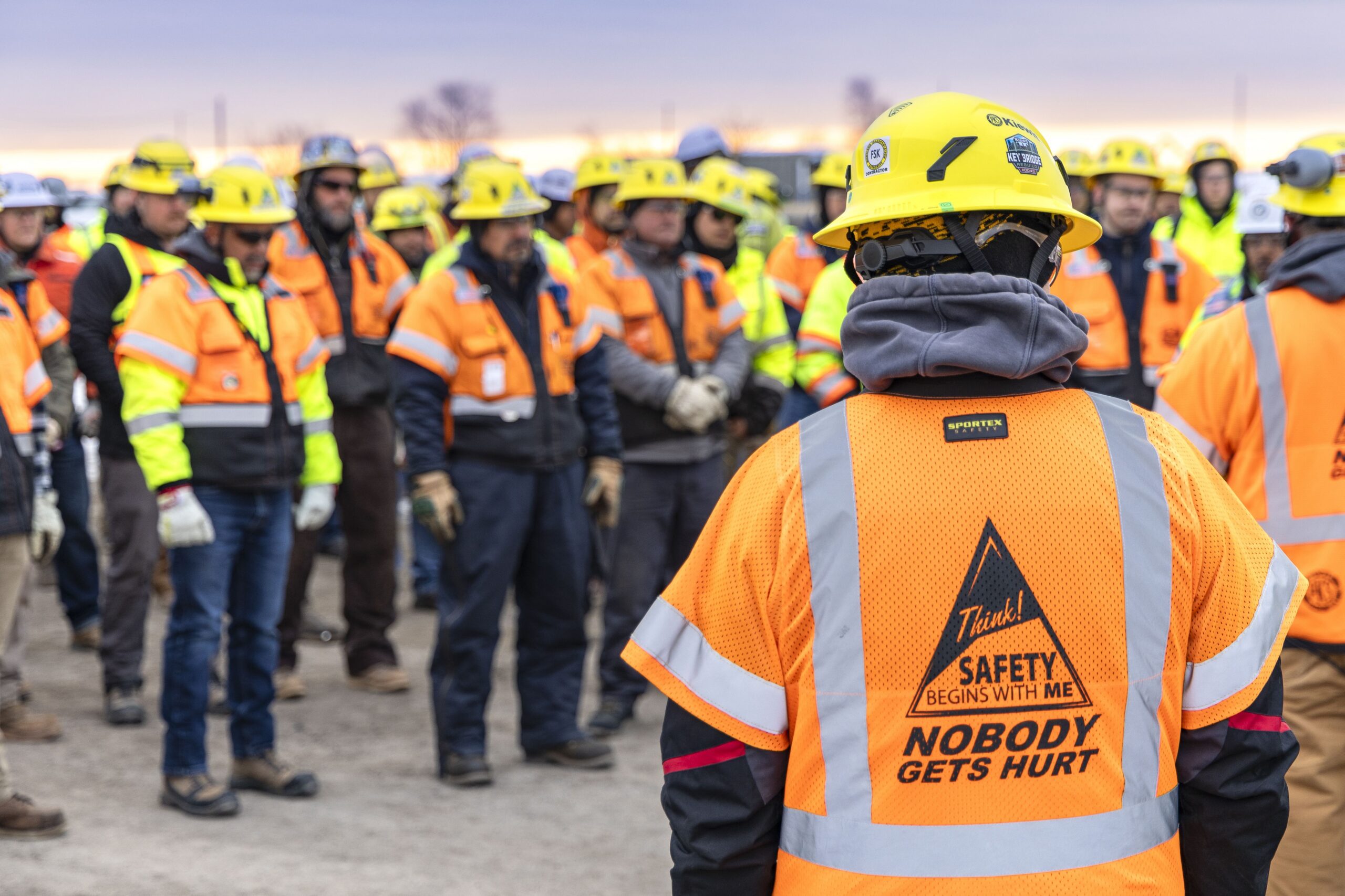 Image of people with hard hats and safety jackets.